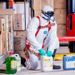 Person Wearing White Suit Holding White Container