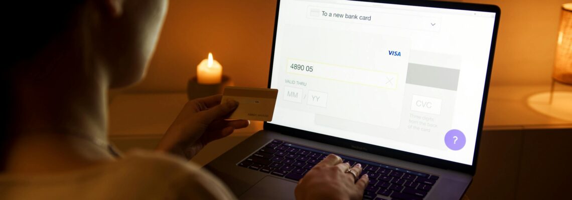 Woman in White Shirt using Laptop doing Online Shopping