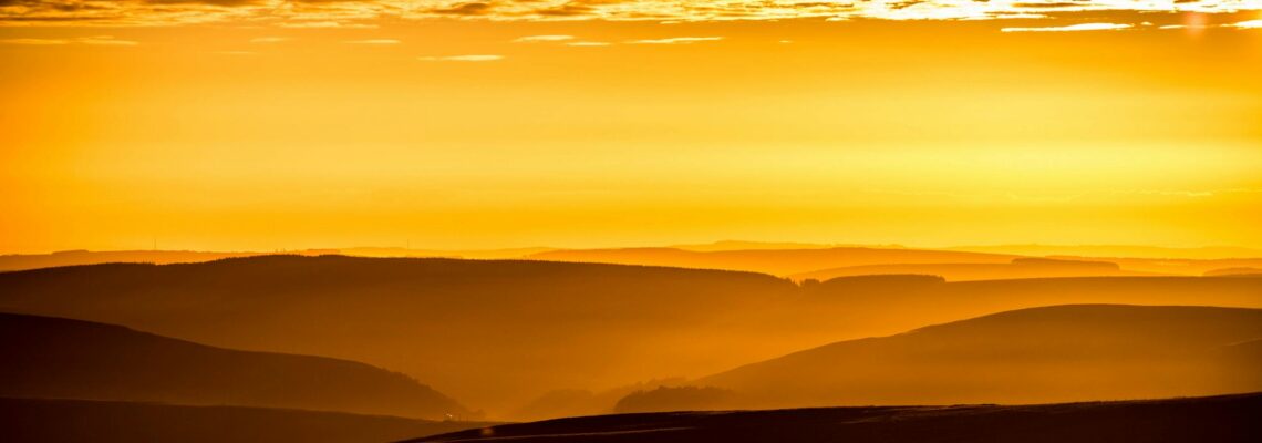 Breathtaking golden sunrise over rolling hills, capturing serene beauty and vibrant colors.