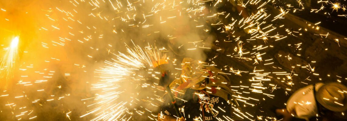 Colorful fireworks bursting in celebration during a vibrant night festival.